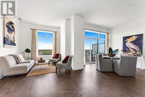 Cambridge condo for rent - A living room with a couch, chairs, and a large window.