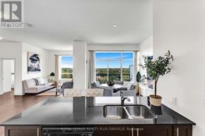 Cambridge condo for rent - A modern kitchen with a large island and a view of the outdoors.