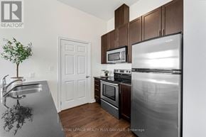 Cambridge condo for rent - A kitchen with a stainless steel refrigerator, microwave, and oven.