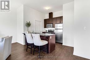 Cambridge condo for rent - A kitchen with white chairs and a white table.
