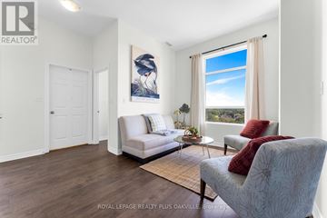 Cambridge condo for rent - A well-lit living room with a couch, chair, and a painting on the wall.