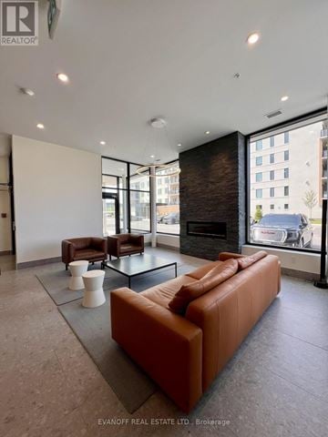 Kawartha Lakes (Fenelon Falls) condo for rent - A living room with a brown couch and a fireplace.