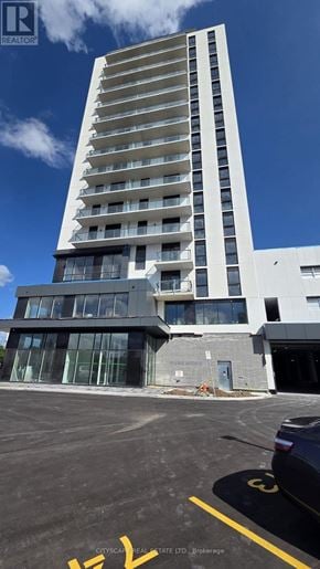 Brantford condo for rent - A view of a parking lot through a window.
