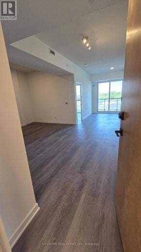 Brantford condo for rent - A white bathroom with a toilet, sink, and towel rack.