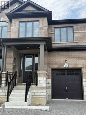 Kawartha Lakes (Lindsay) townhouse for rent - A two-story house with a black garage door.