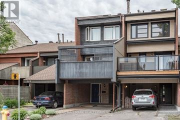 Ottawa townhouse for rent - A modern two-story house with a balcony and a garage.