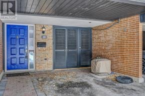 Ottawa townhouse for rent - A blue door is on the left side of a brick building.