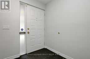 Ottawa townhouse for rent - A white door with a gold handle and a blue sign on the wall.