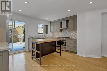 Ottawa townhouse for rent - A kitchen with a table and chairs in the middle of the room.