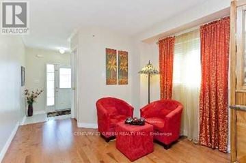 Milton (Cl Clarke) apartment for rent - A living room with two red chairs and a lamp.