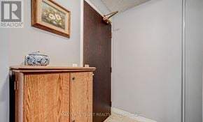 Toronto (Waterfront Communities) condo for rent - A wooden cabinet with a vase on top and a painting on the wall.