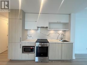 Toronto (Church-Yonge Corridor) condo for rent - A modern kitchen with a stove top oven and microwave.