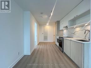 Toronto (Church-Yonge Corridor) condo for rent - A modern kitchen with wooden floors and white walls.