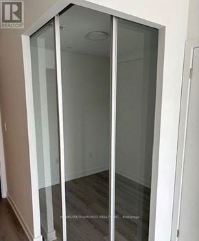 Oakville (Jm Joshua Meadows) condo for rent - A glass door in a room with a wooden floor.