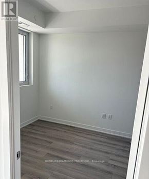 Oakville (Jm Joshua Meadows) condo for rent - A room with a window and wooden flooring.