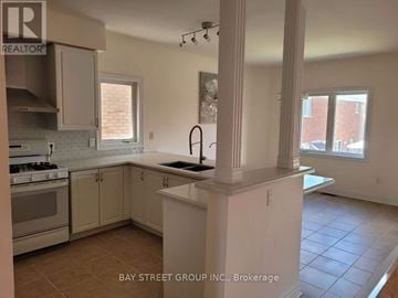 Markham (Berczy) apartment for rent - A kitchen with white cabinets and a tiled floor.