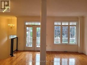 Markham (Berczy) apartment for rent - A room with a chandelier, a door, and a window.