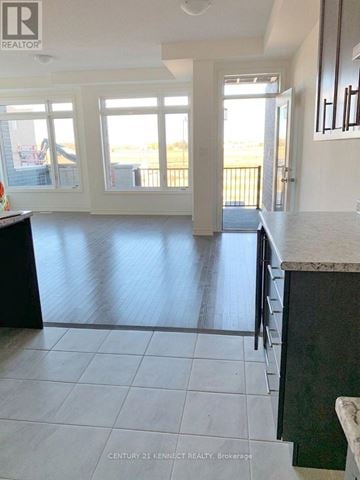 Brampton (Northwest Brampton) townhouse for rent - A kitchen with a black counter top and white cabinets.