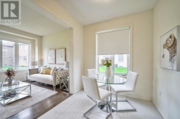 Whitby apartment for rent - A living room with a glass table and white chairs.