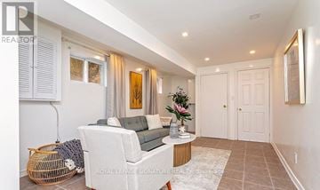 Mississauga (Erin Mills) apartment for rent - A living room with a white sofa and a wooden coffee table.