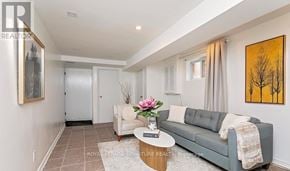 Mississauga (Erin Mills) apartment for rent - A living room with a grey couch, a coffee table, and a painting on the wall.
