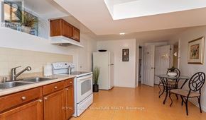 Mississauga (Erin Mills) apartment for rent - A kitchen with wooden cabinets and a white fridge.