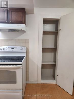Mississauga (Erin Mills) apartment for rent - A white oven in a kitchen with a white cabinet and a white door.