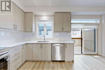 Brant (Paris) townhouse for rent - A kitchen with wooden cabinets and a stainless steel dishwasher.