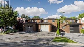 Richmond Hill (North Richvale) apartment for rent - A row of houses with garages are shown in a sunny day.
