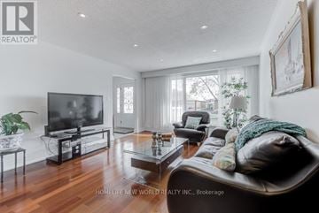 Mississauga (Erindale) apartment for rent - A living room with a black leather couch and a flat screen TV.
