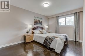 Mississauga (Erindale) apartment for rent - A bedroom with a bed, nightstand, and a painting on the wall.