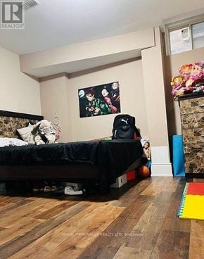 Brampton (Toronto Gore Rural Estate) apartment for rent - A room with a bed, a painting, a backpack, and a small child.