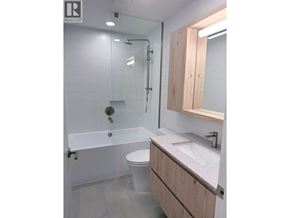 Squamish apartment for rent - A bathroom with a toilet, sink, and shower.