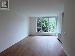 Squamish apartment for rent - A room with wooden flooring and a window overlooking a garden.