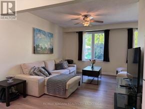 Welland (N. Welland) apartment for rent - A living room with a couch, a coffee table, and a painting on the wall.