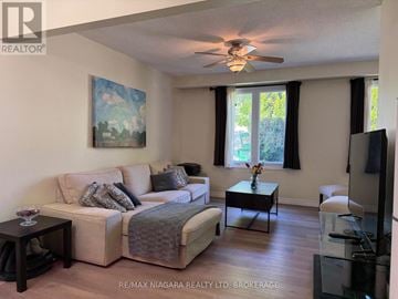 Welland (N. Welland) apartment for rent - A living room with a couch, a coffee table, and a painting on the wall.