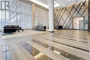 Toronto (Henry Farm) condo for rent - A spacious lobby with a black sofa and a glass table.