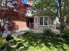 Ancaster apartment for rent - A house with a red tree in front.
