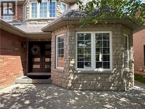 Ancaster apartment for rent - A house with a stone wall and a brown door.