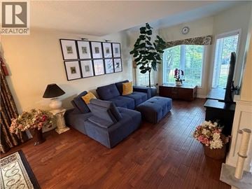 Ancaster apartment for rent - A living room with a blue couch and a wooden floor.