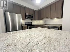 Burnaby apartment for rent - A kitchen with a granite countertop and stainless steel appliances.