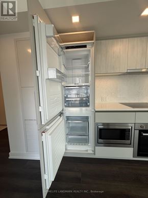 Toronto (North St. James Town) condo for rent - A white refrigerator with its door open in a kitchen.