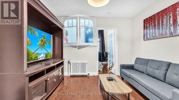 London East (East K) multi-family for rent - A living room with a grey couch and a wooden coffee table.