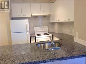 Toronto (Woburn) condo for rent - A kitchen with granite countertops and white appliances.