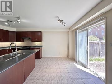 Ajax (Northeast Ajax) apartment for rent - A kitchen with brown cabinets and a stainless steel sink.