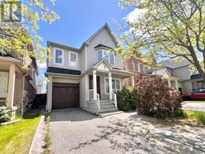 Ajax (Northeast Ajax) apartment for rent - A house with a driveway and a tree in front of it.