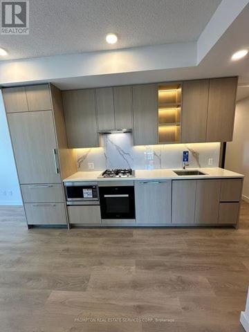 Toronto (Bayview Village) condo for rent - A kitchen with a stove top oven and a microwave.