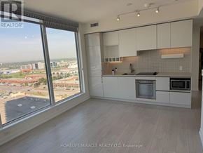 Vaughan (Vaughan Corporate Centre) condo for rent - A kitchen with white cabinets and a view of the city.