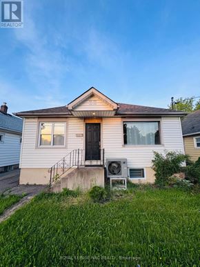 St. Catharines (Western Hill) apartment for rent - A house with a black door and a small porch.