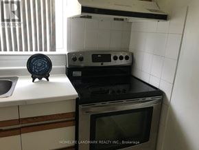 Toronto (L'amoreaux) townhouse for rent - A black oven with a microwave on top of it.